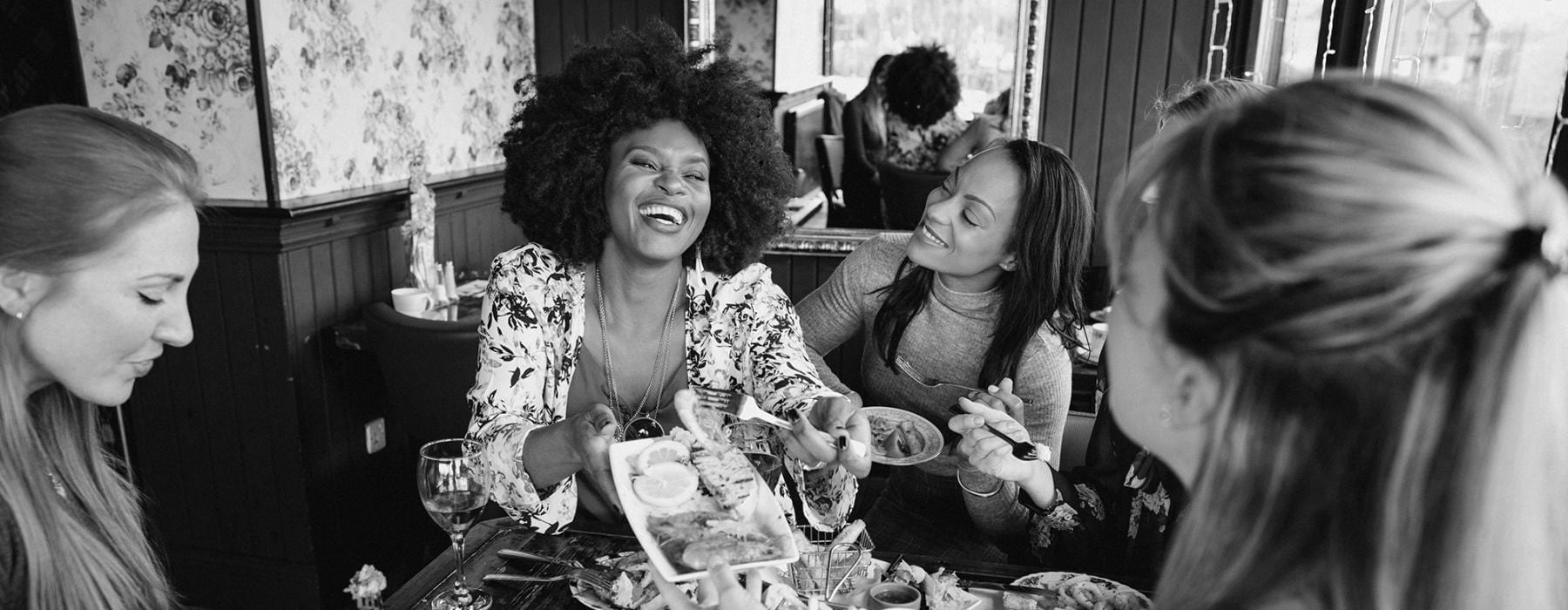 a group of women eating at a table