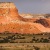 a landscape with a large rock formation